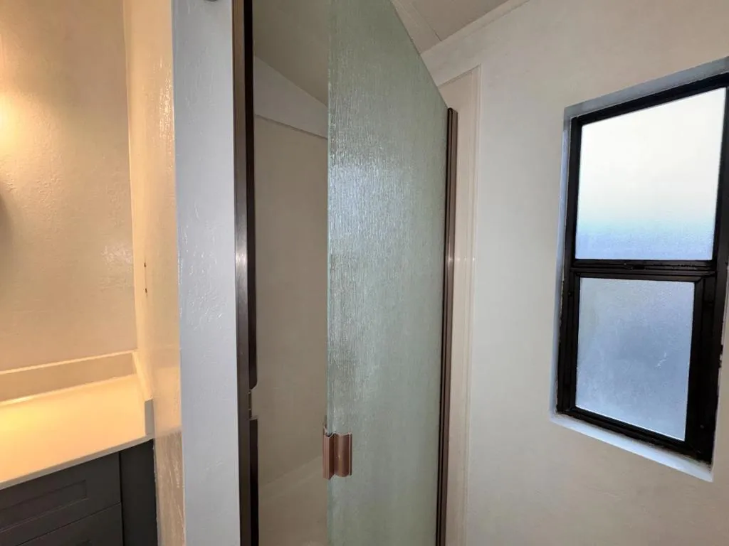 Shower with pebbled glass door.