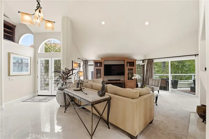 The Shinny Travertine Floor Entry Leads To The Living Room & Sliding Glass Door To The Balcony