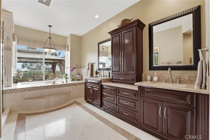 Check Out The Detail Of The Tumbled Travertine Wall Over the Sinks. There Is A Large Walk In Closet Off The Ensuite Bath
