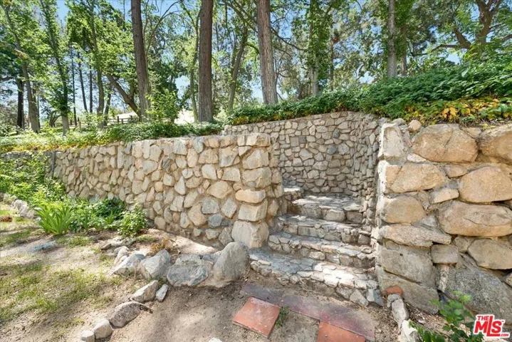 Old rock wall by courtyard gar