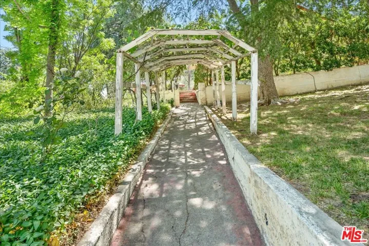 Rose trellis walkway leading t