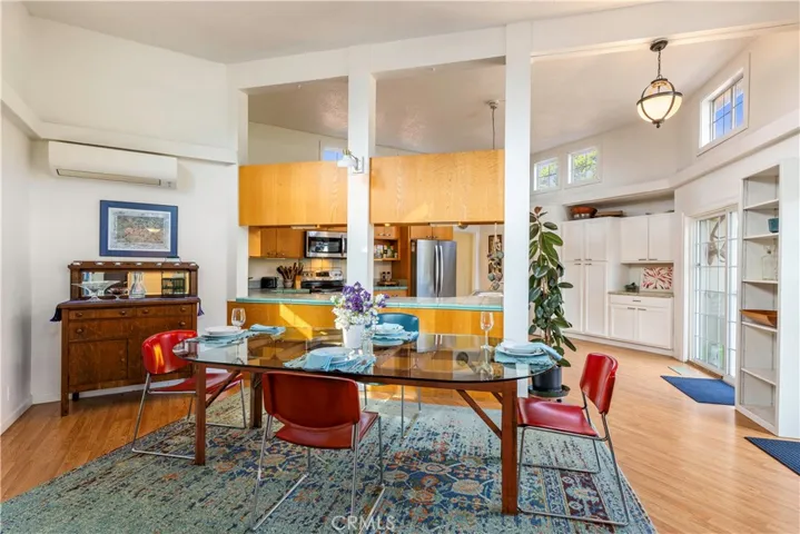 Dining area with high ceiling and sliding glass doors to the back patio and back yard.