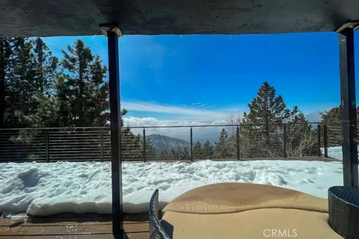 View of the deck from inside the log cabin