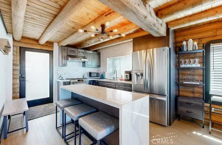 Glass door entry into the kitchen with island