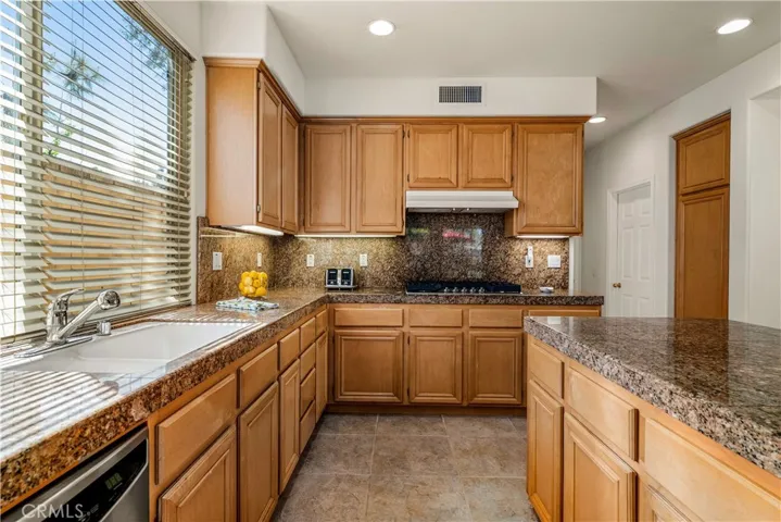 DOUBLE SINKS WITH BUILT IN RECYCLING BINS AND UNDER CABINET LIGHTING - NEW STAINLESS STEEL EXHAUST FAN WAS JUST INSTALLED