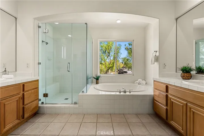 THE PERFECT ENSUITE WITH DUAL SINKS, AND SEPARATE SOAKING TUB AND SHOWER WITH GLASS ENCLOSURE