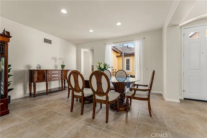 FORMAL DINING SPACE WITH PLENTY OF NATURAL LIGHT AND DIRECT ACCESS TO FRONT COURTYARD
