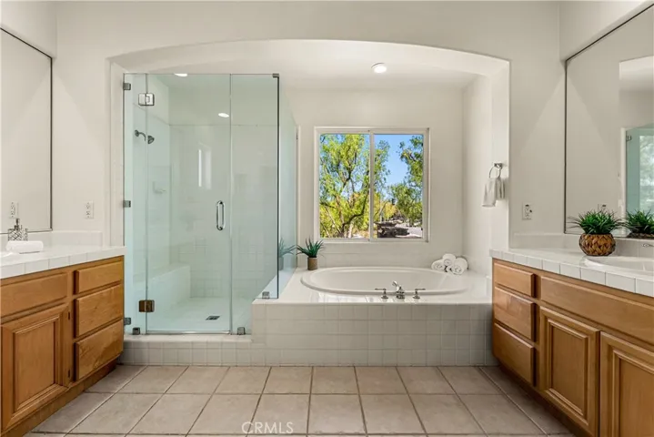 THE PERFECT ENSUITE WITH DUAL SINKS, AND SEPARATE SOAKING TUB AND SHOWER WITH GLASS ENCLOSURE