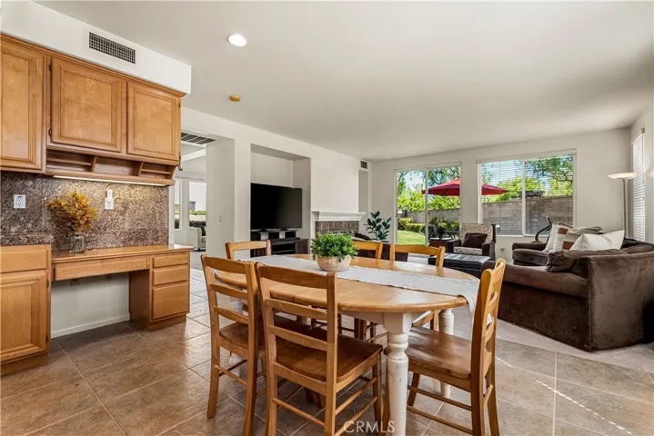 VIEW OF BUILT IN DESK IN KITCHEN, BREAKFAST NOOK INTO SPACIOUS FAMILY ROOM