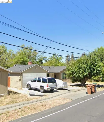 View of front of home with driveway and a garage