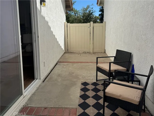 Enclosed side yard with vinyl fencing.