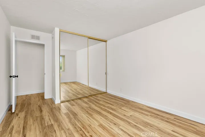 Secondary Bedroom with mirrored wardrobe doors.