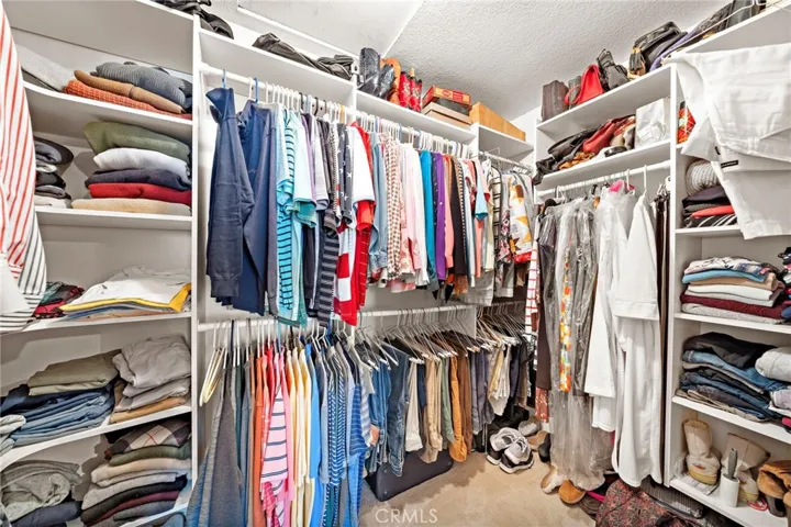 Primary suite walk-in closet with custom built-in