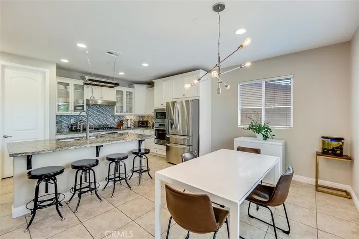Open layout with center island seating and dining space