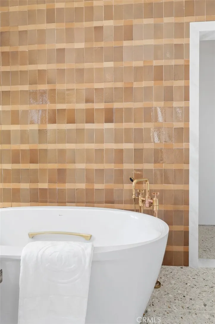 Gorgeous hand made, custom Italian tile in earth tones with brass fixtures