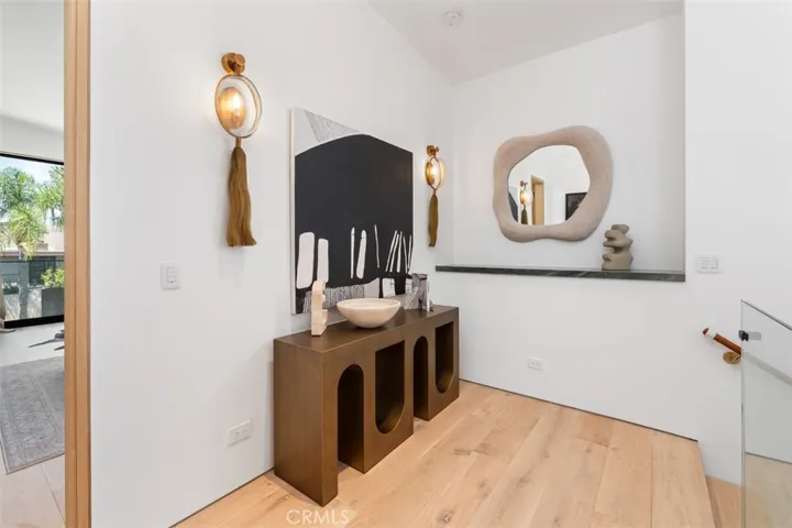 Upstairs hallway with bespoke light fixtures mimic horse tail