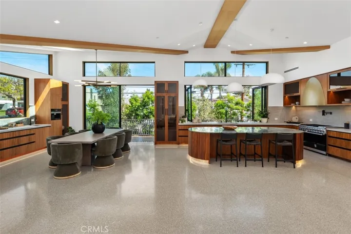 Kitchen and dining room with sliding door for seamless access to out door kitchen