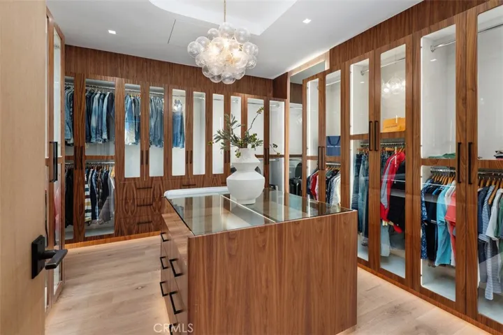 The walk in closet everyone dreams about with custom light fixture