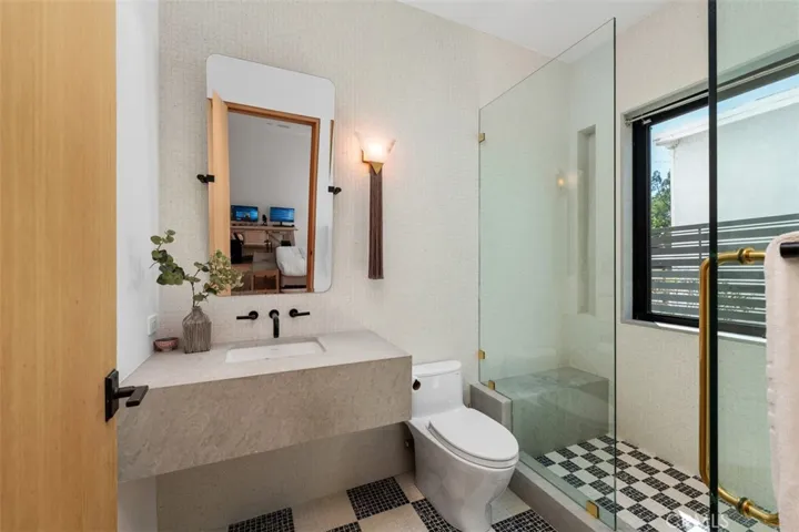 Beautiful, custom Italian tile with bespoke light fixture mimics a horse tail