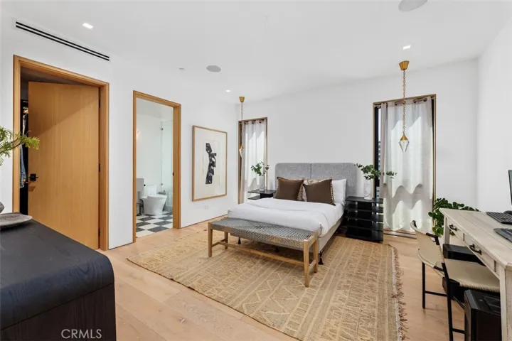 Second bedroom on main level with beautiful light fixtures and en-suite