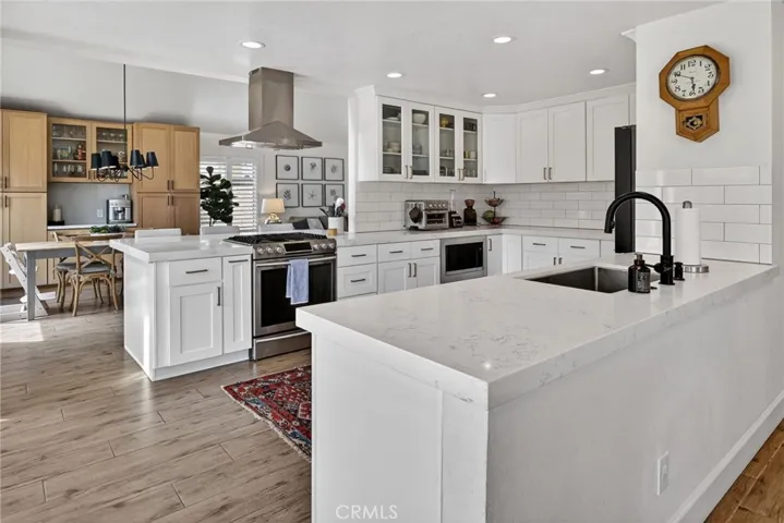Expanded and remodeled kitchen with quartz countertops and recessed lighting