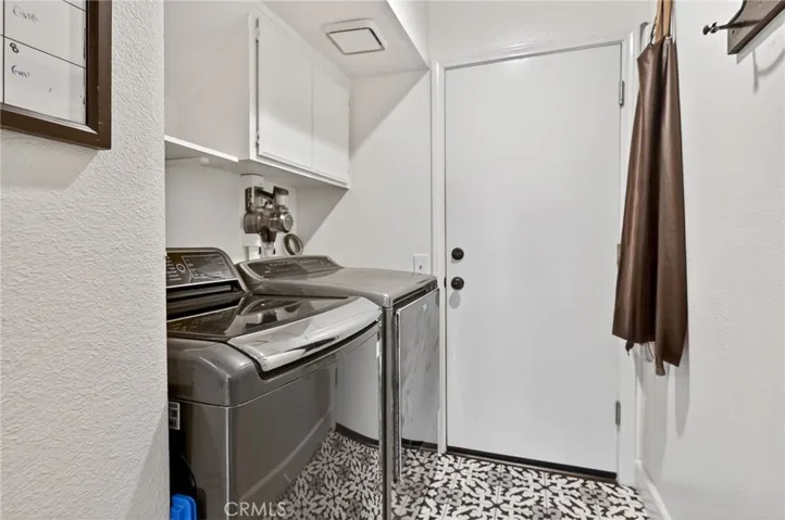 Laundry room with nice tile flooring.   The door leads to the garage.