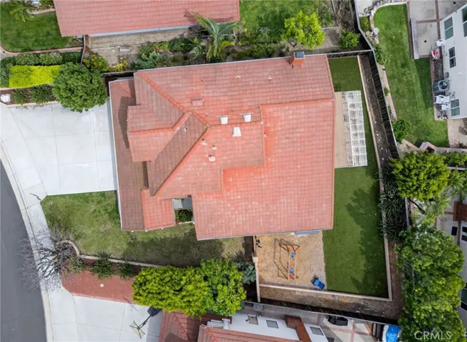 The home features an extended driveway and turf backyard