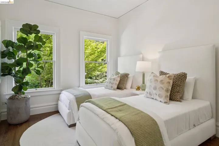 Bedroom featuring wood finished floors and baseboards