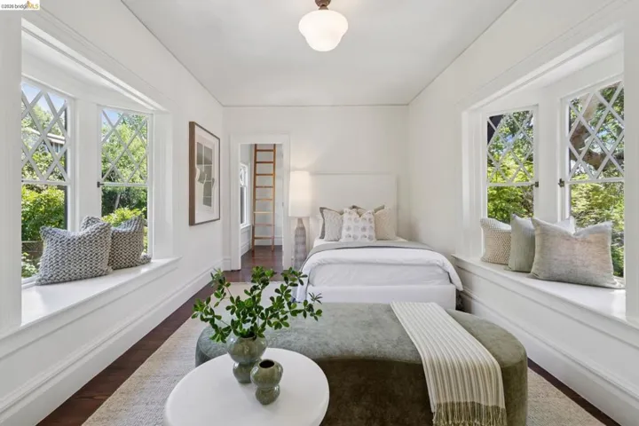 Bedroom featuring dark wood finished floors and multiple windows
