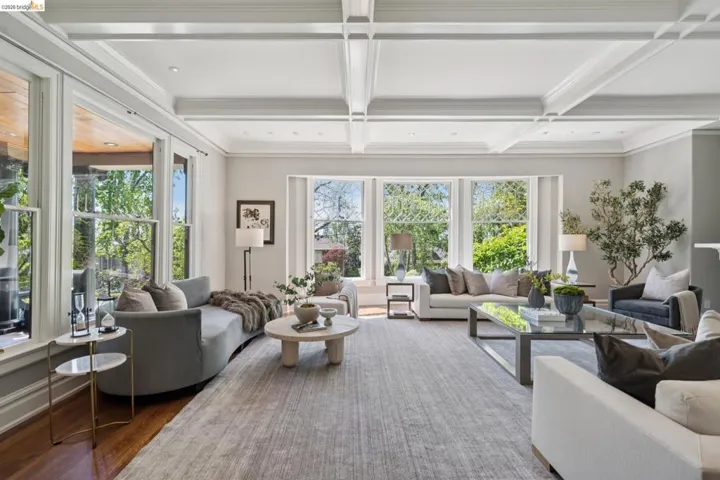 Living room with coffered ceiling, wood finished floors, and recessed lighting