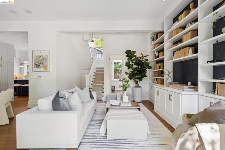Living room featuring stairs and dark wood-style floors