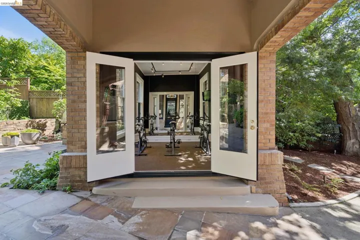 Doorway to property featuring brick siding and stucco siding
