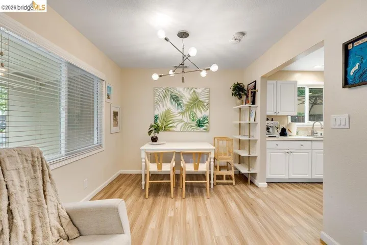 Dining area with light wood-style flooring and a chandelier