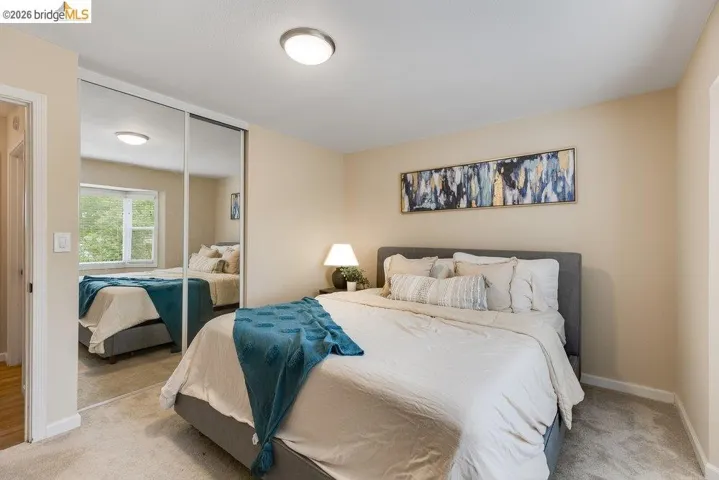 Bedroom with a closet and light colored carpet