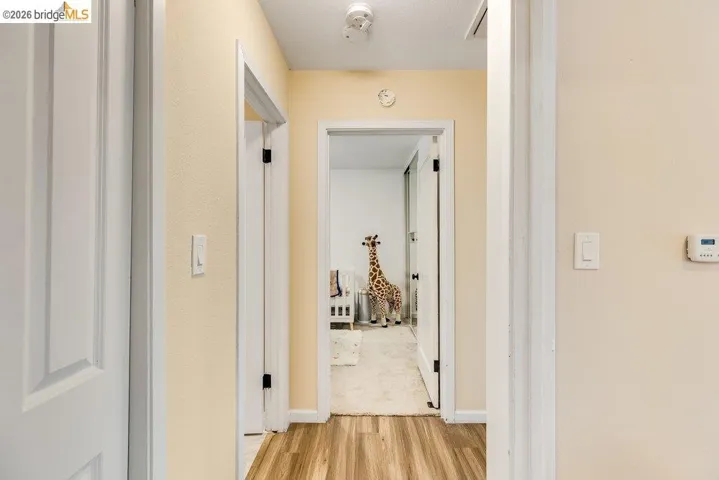 Hall with light wood-type flooring and baseboards