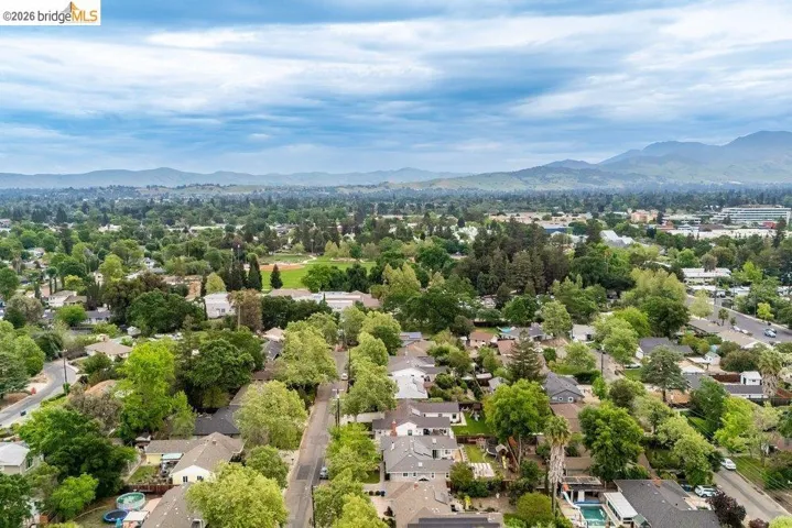 Aerial view of residential area featuring a mountainous background