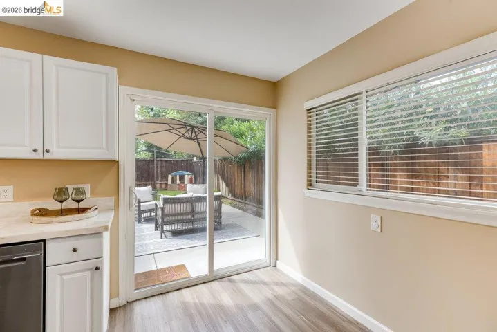 Dining space with light wood-style flooring and baseboards