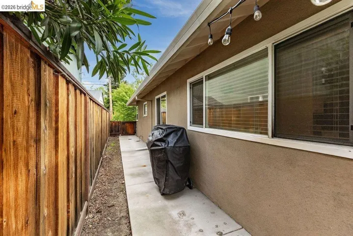 Fenced backyard with a grill