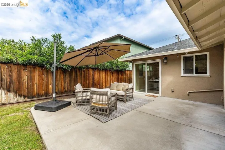 Fenced backyard featuring outdoor furniture and a patio