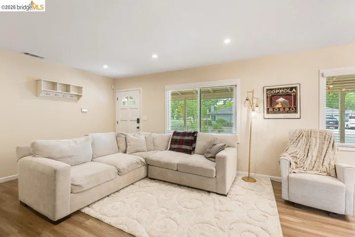 Living room with wood finished floors and recessed lighting