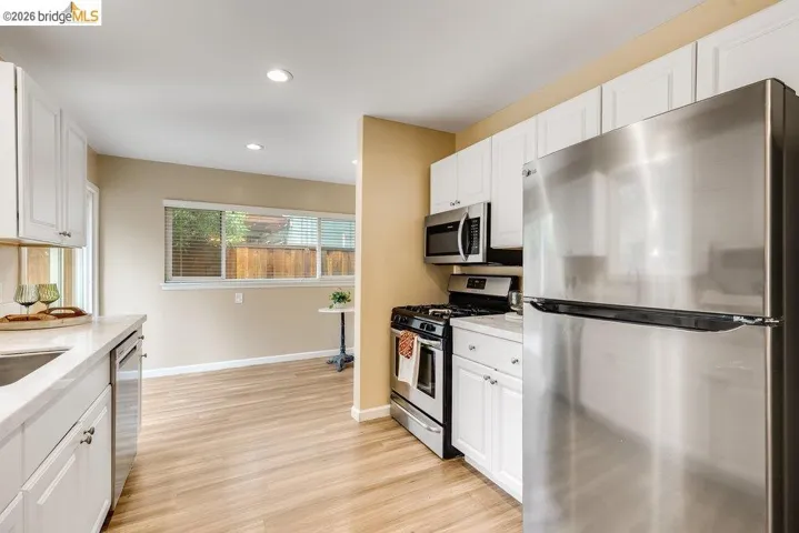 Kitchen featuring stainless steel appliances, white cabinetry, recessed lighting, and light wood-style flooring