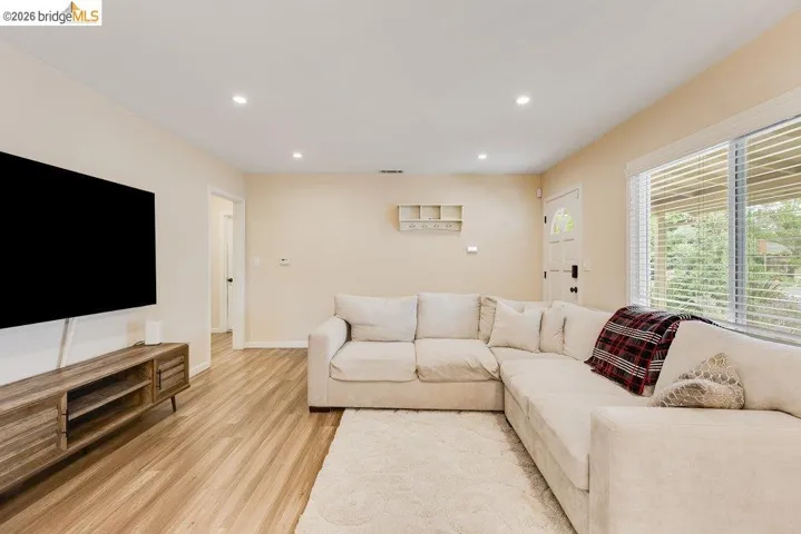 Living room featuring recessed lighting and light wood-style flooring