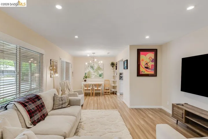 Living room with a chandelier and light wood-style flooring