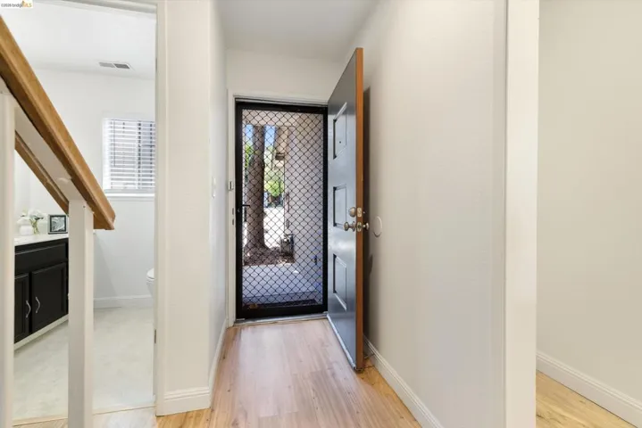 Entrance foyer with light wood finished floors and baseboards