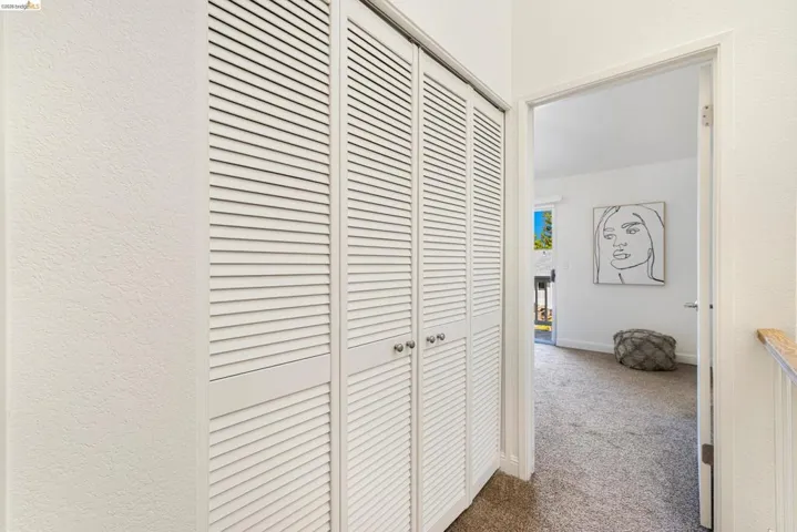 Hallway featuring carpet flooring and baseboards