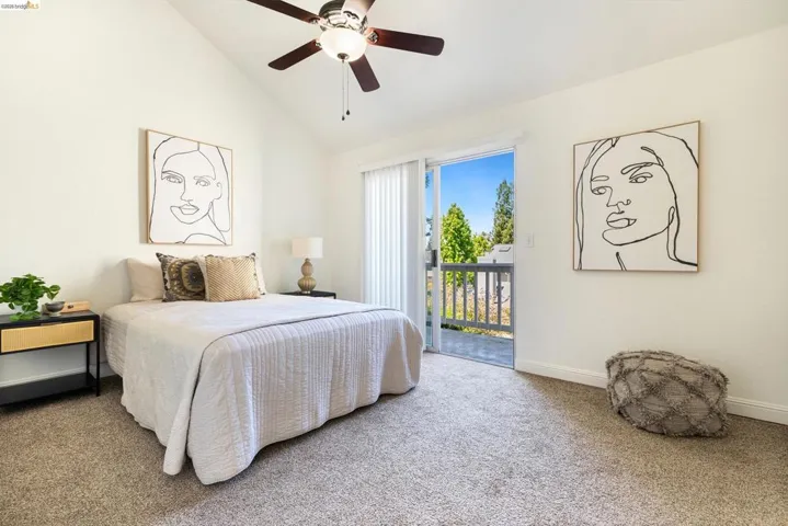 Bedroom featuring carpet, vaulted ceiling, access to outside, and a ceiling fan