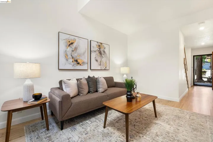 Living room featuring light wood-style flooring and baseboards