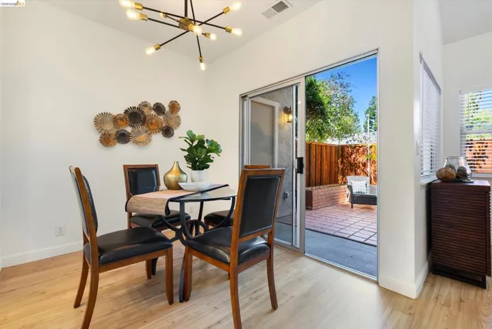Dining area featuring suspended lighting and light wood-type flooring