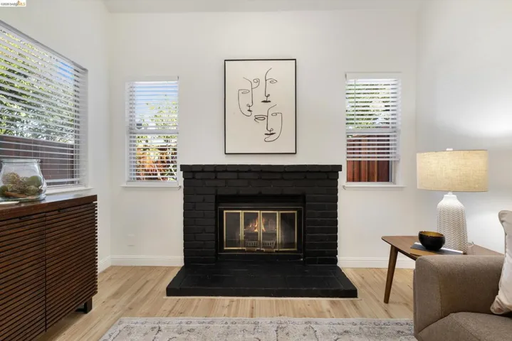Detailed view of wood finished floors and a brick fireplace