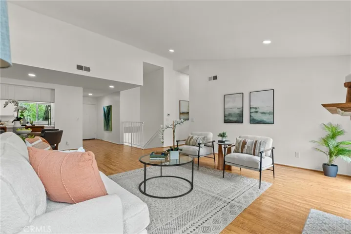 Family room open to kitchen, stair to garage.